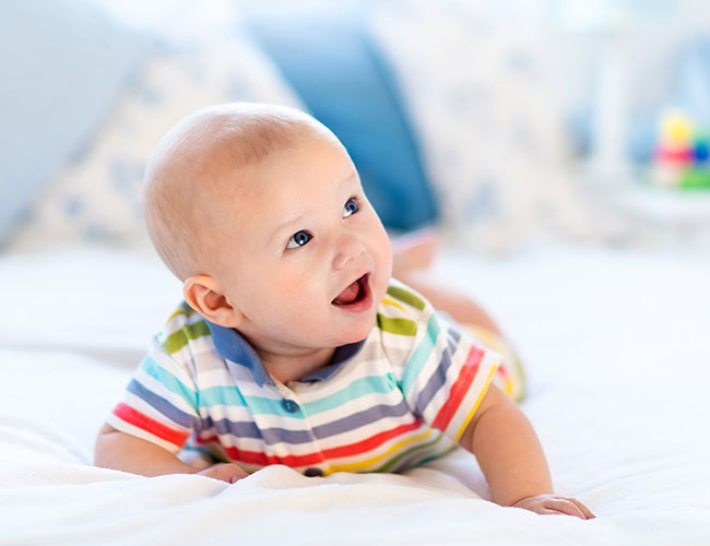 Young baby holding up his own head.