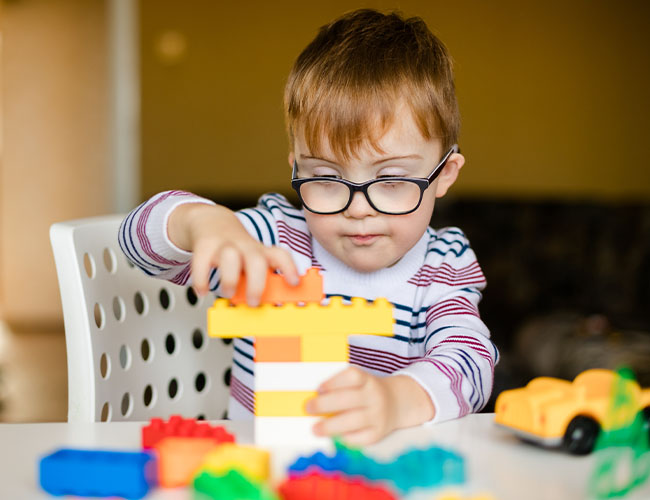 19 - 24 month old playing with large blocks.