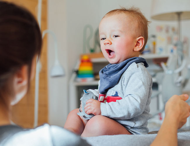 7 - 9 month old baby interacting with mom.